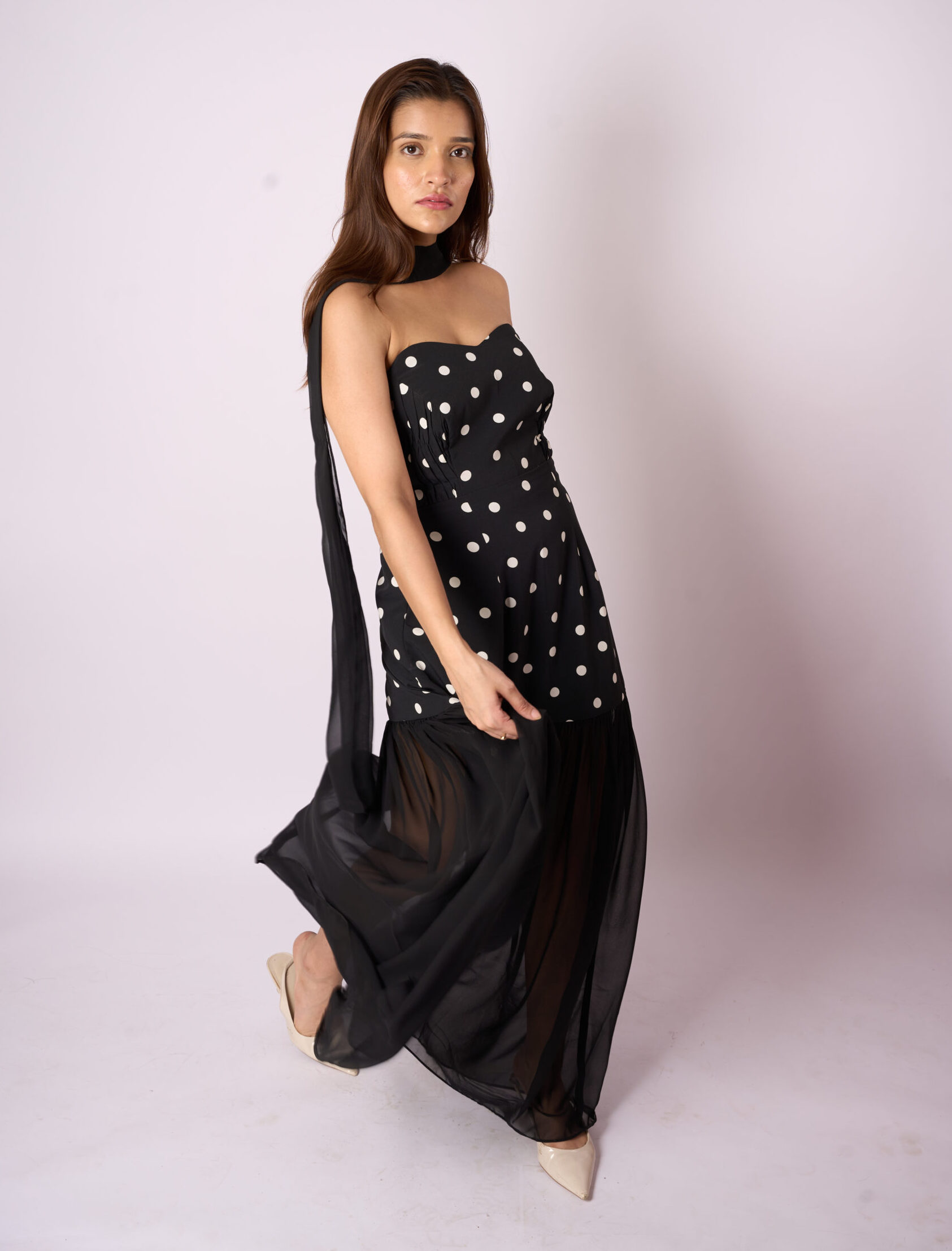 Woman wearing a timeless midi dress styled with minimal accessories, representing versatile and everyday elegance.